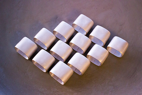 A set of 12 fine silver napkin rings